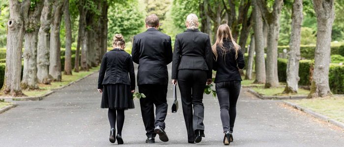 family walking in funeral service family walking in funeral service